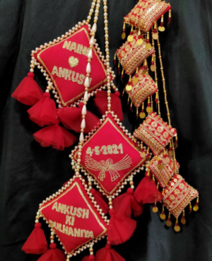 Red personalised lehenga hanging with tassel latkans